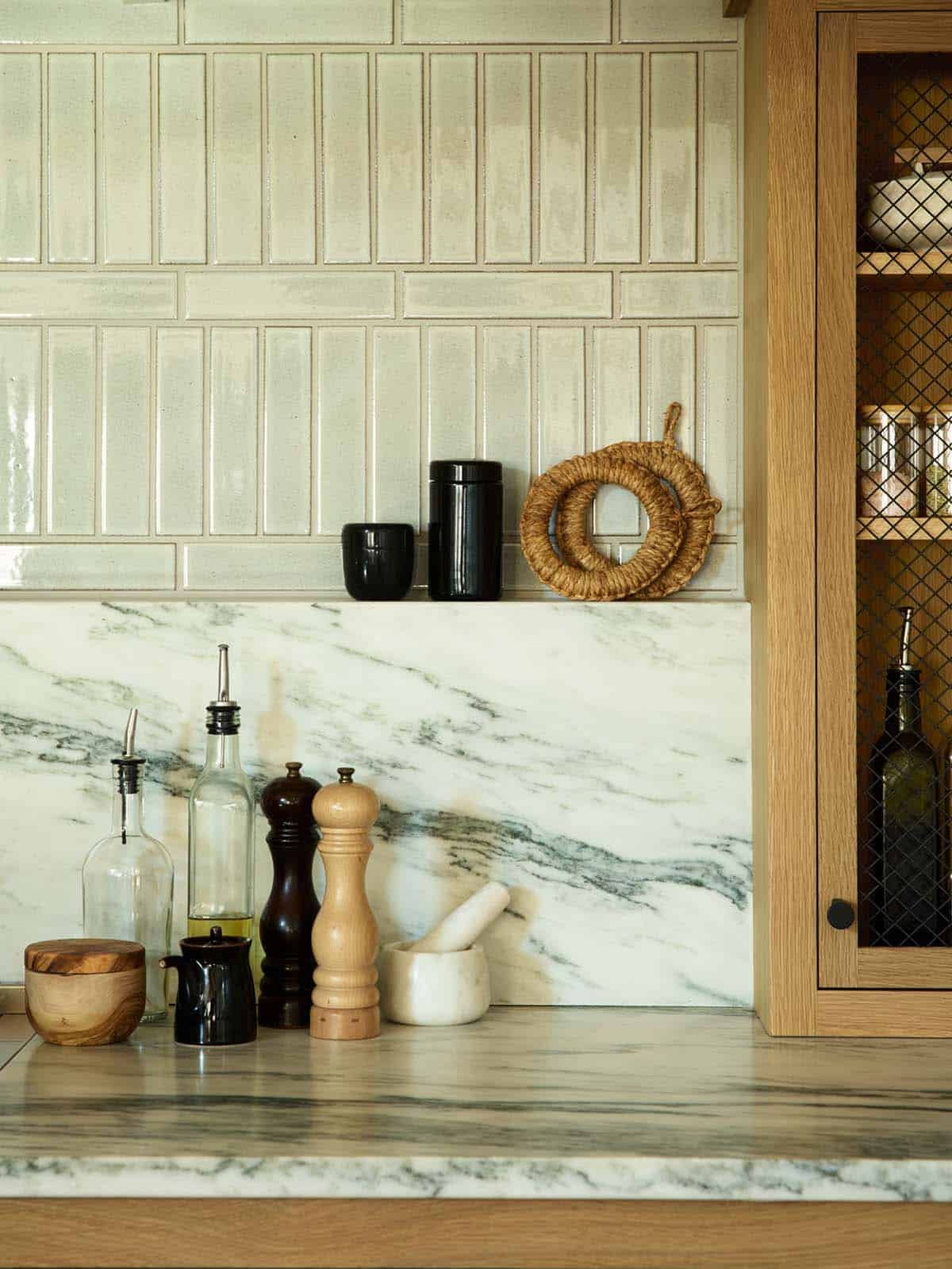 kitchen marble backsplash detail with pepper mills