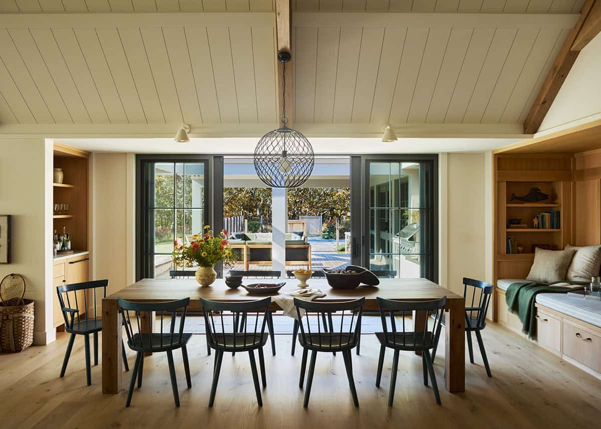 Dining room with black windsor chairs and a globe pendant light