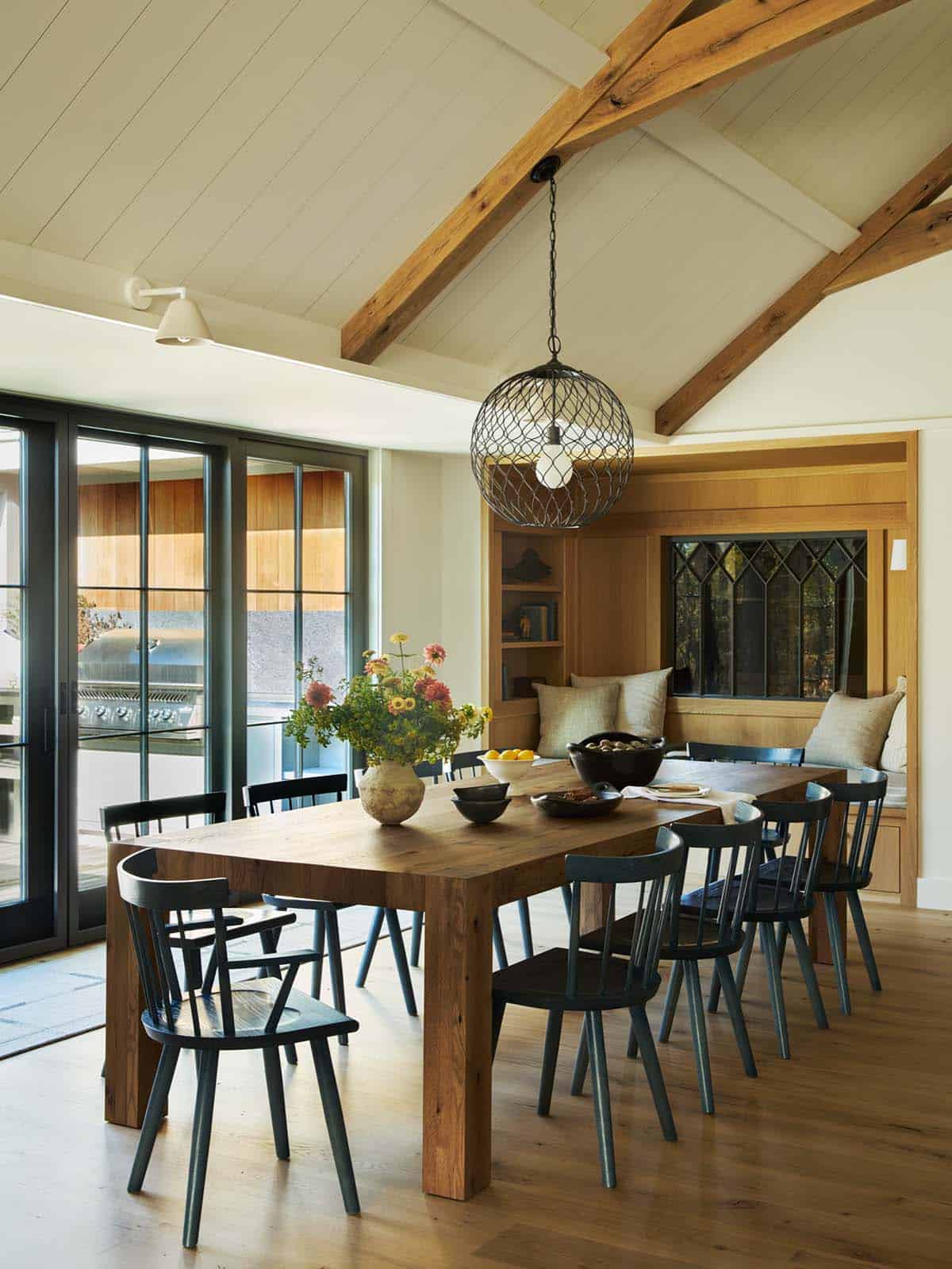Dining room with wood table, black chairs and built-in window seat