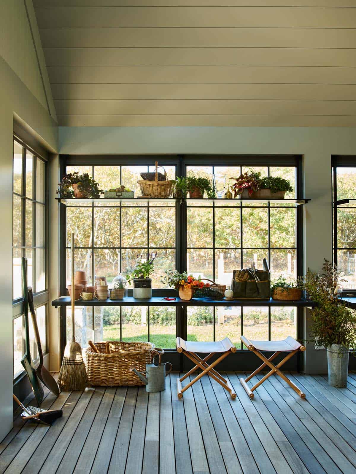 Potting room with tiered shelving and folding canvas stools