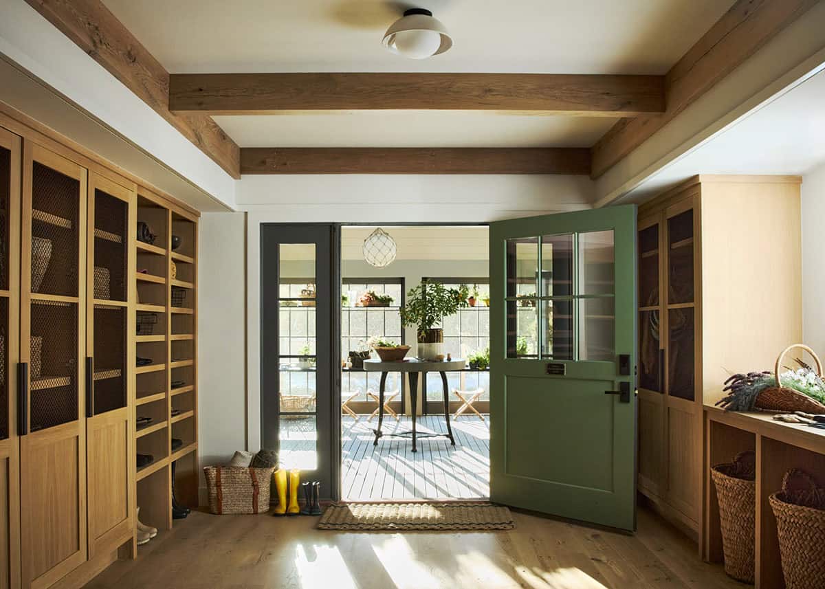 Mudroom with mesh-front cabinets and open green Dutch door