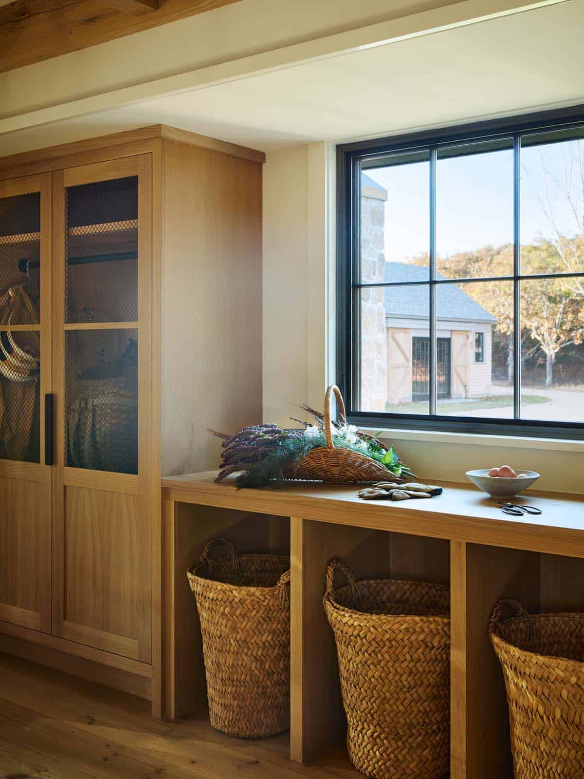 Mudroom with woven baskets and a window view