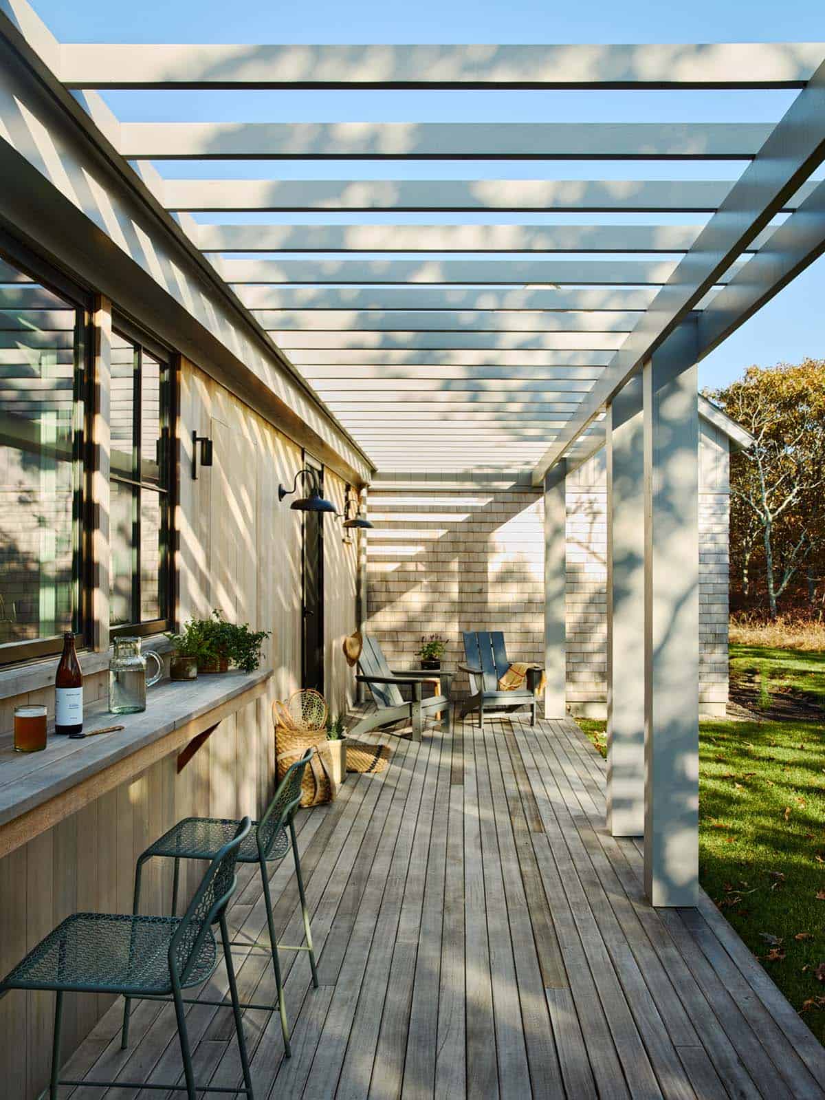 Covered walkway with pergola beams and a built-in outdoor bar counter