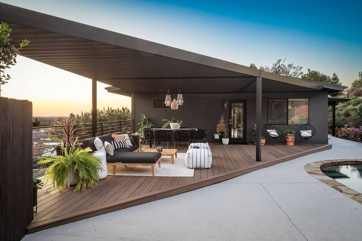 Mid-century covered deck lounge and dining area in San Diego, California overlooking pool