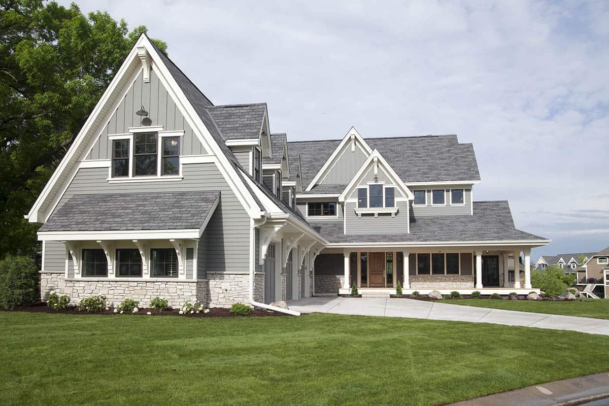 Craftsman home exterior with steep gabled roof, stone base, and covered front porch