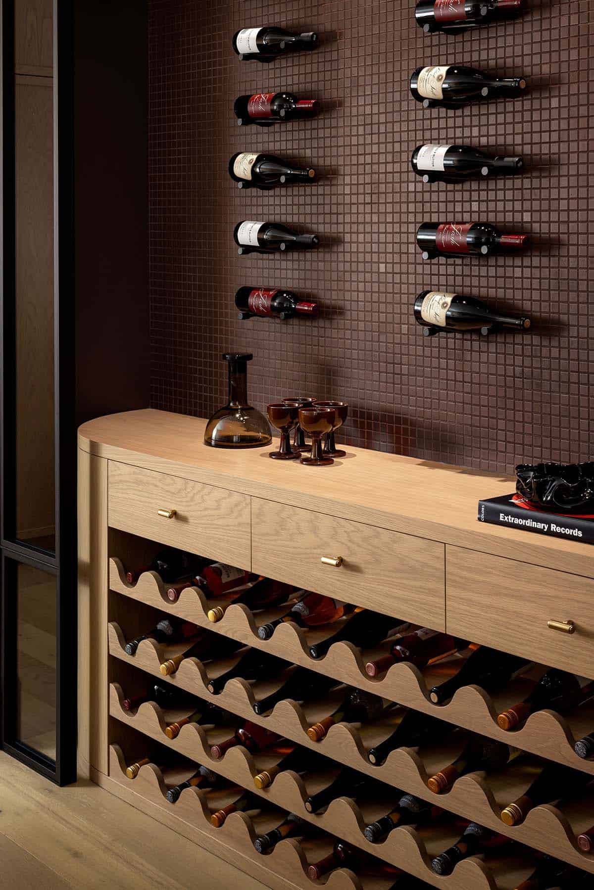 Wine cellar with wall-mounted bottle display and built-in wooden storage shelves