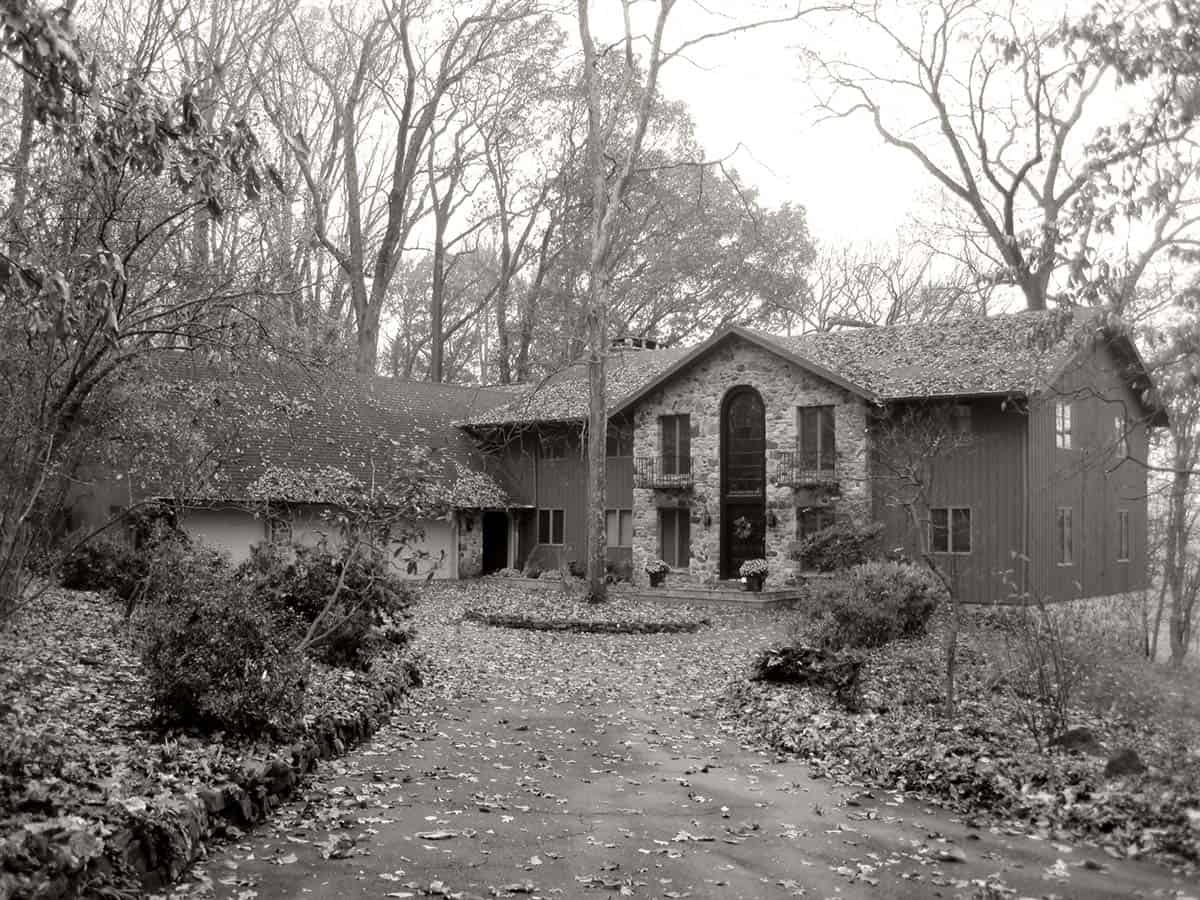 Black and white photo of original 1970s stone home before renovation