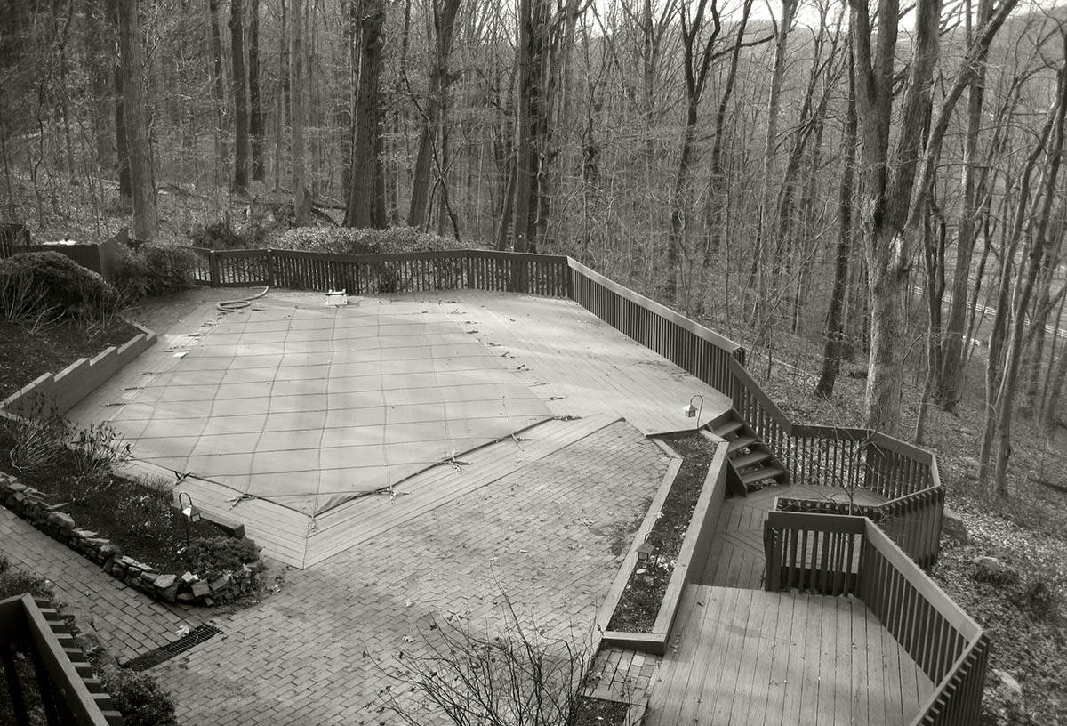 Original wood deck with covered pool before the renovation