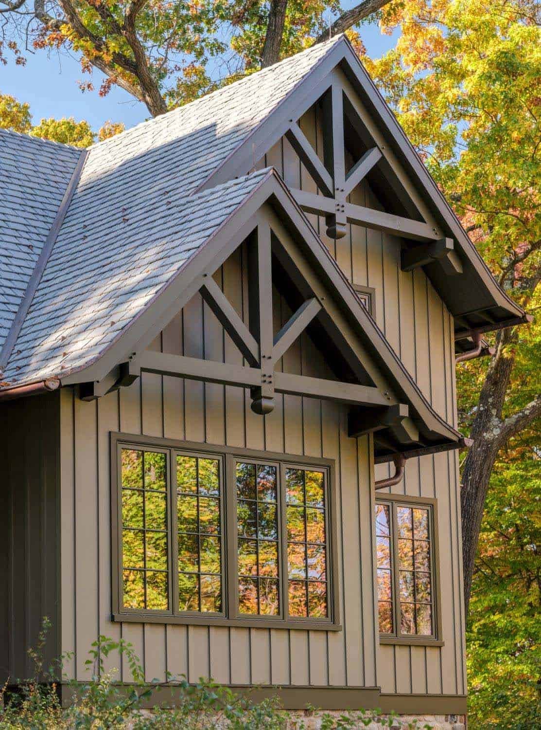 Gabled dormers with exposed timber trusses over board and batten siding