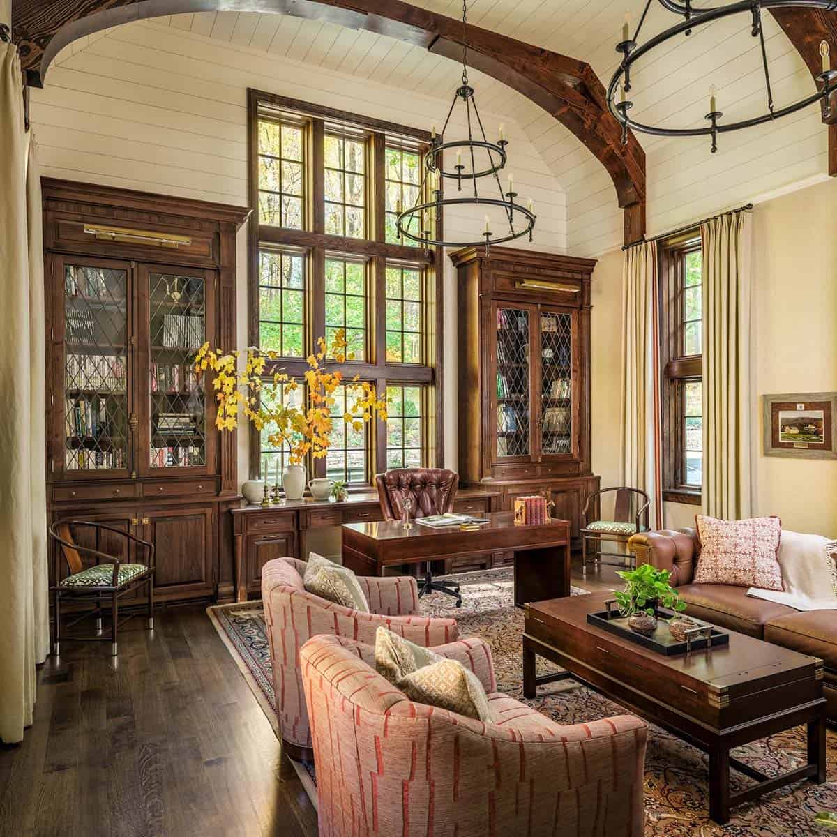 Wood-paneled study with vaulted ceiling and iron ring chandeliers