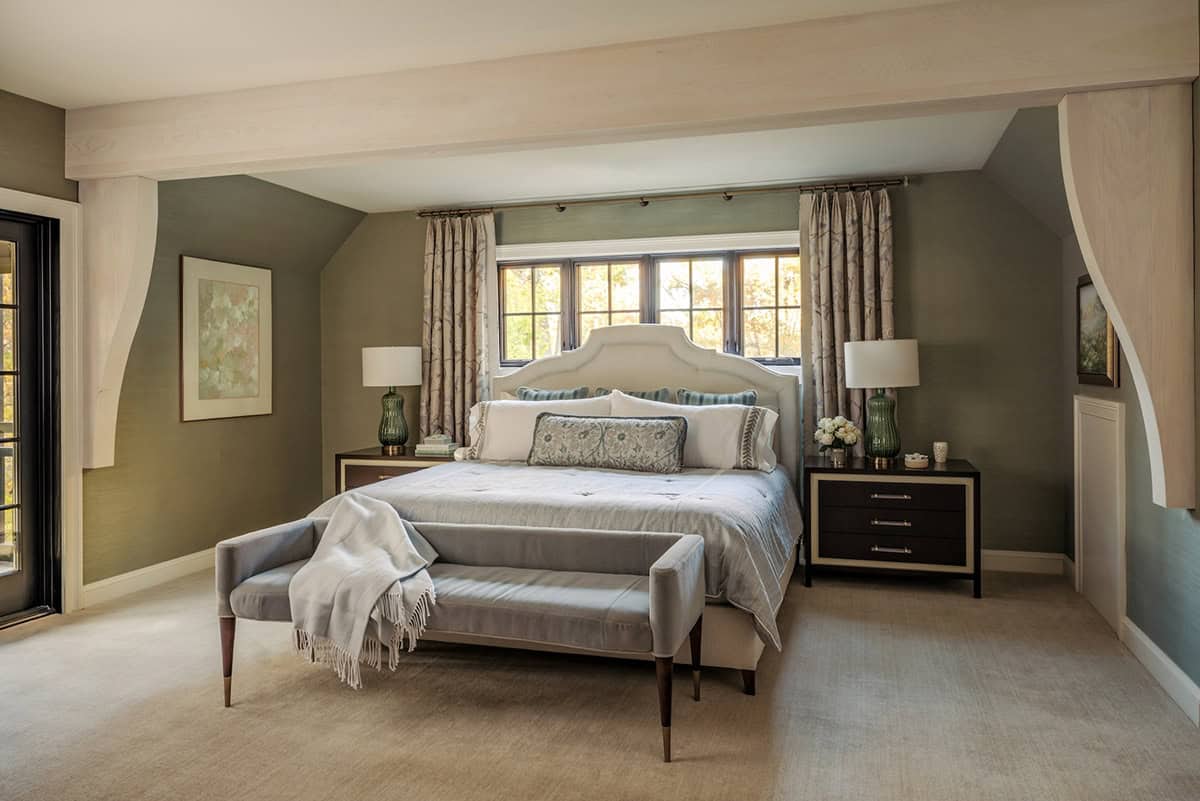 Primary bedroom with sage walls and curved timber ceiling brackets