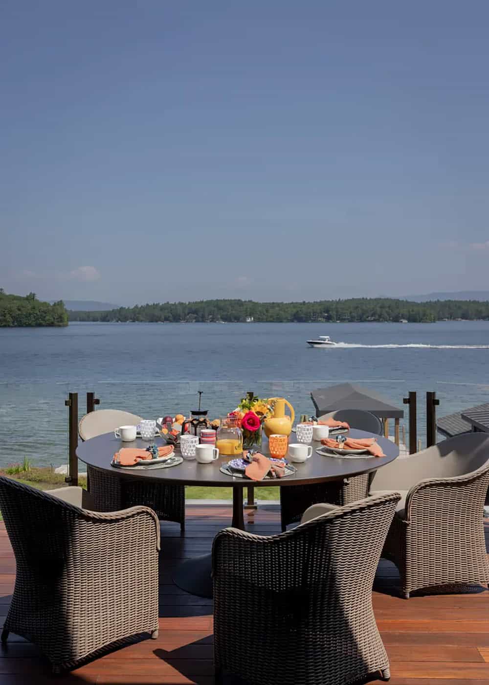 Outdoor dining table set for breakfast overlooking Lake Winnipesaukee