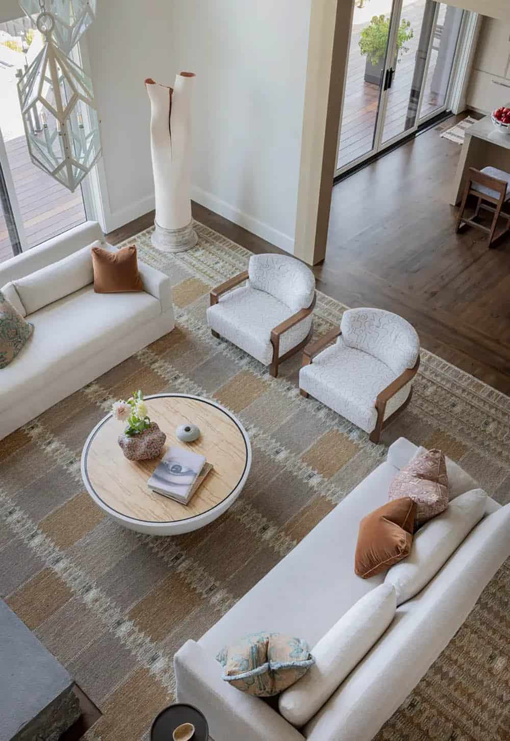 Overhead view of a living room with patterned rug and sofas
