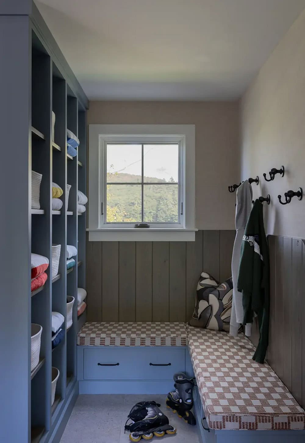 Mudroom with built-in cubbies, striped bench, and window seat