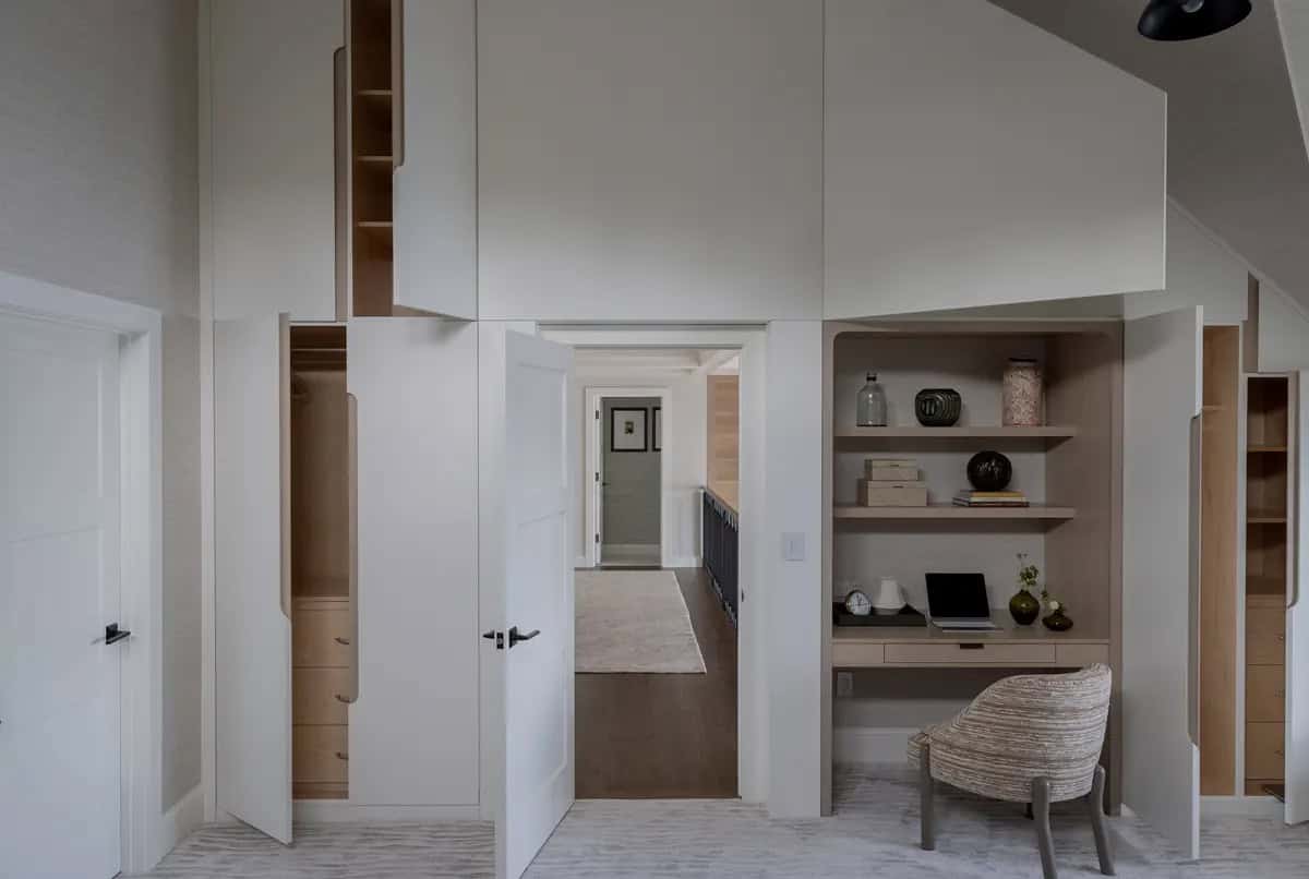 Built-in closets and desk nook tucked beneath a sloped ceiling