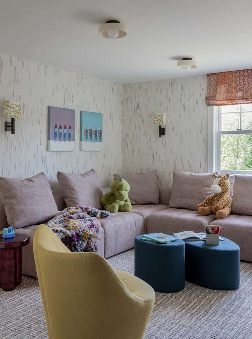 Playroom with sectional sofa, stuffed animals, and patterned wallpaper