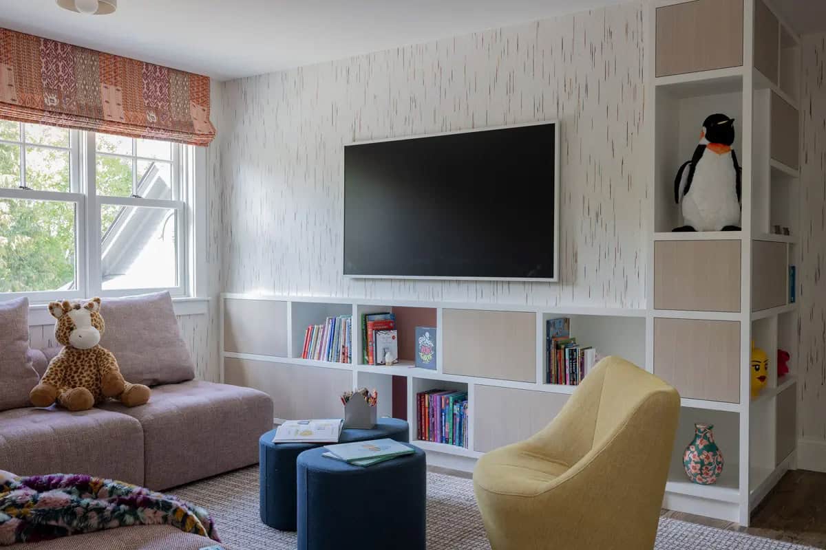 Playroom media wall with built-in cubbies and stuffed animals