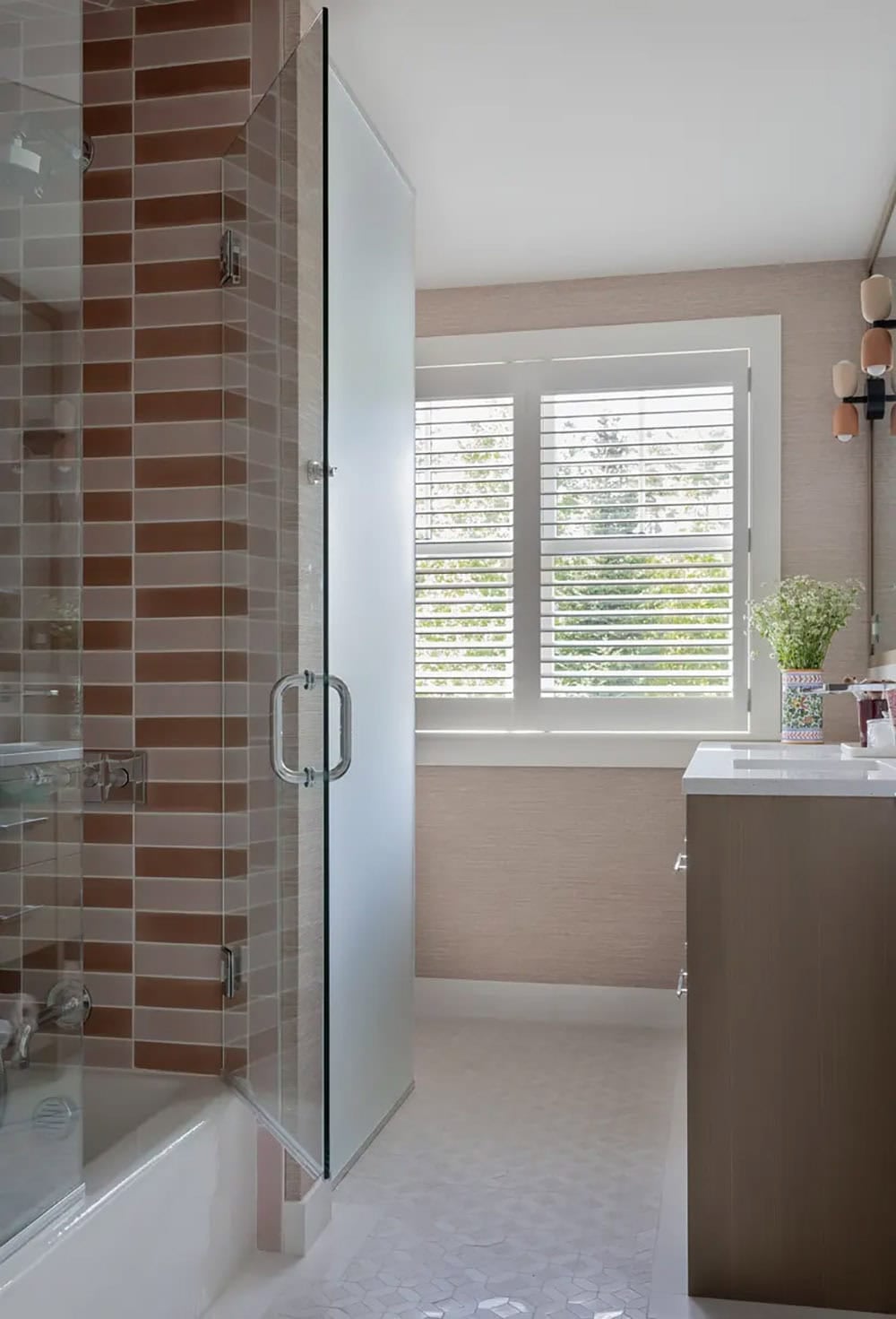 Bathroom with terracotta tile shower and frosted glass door