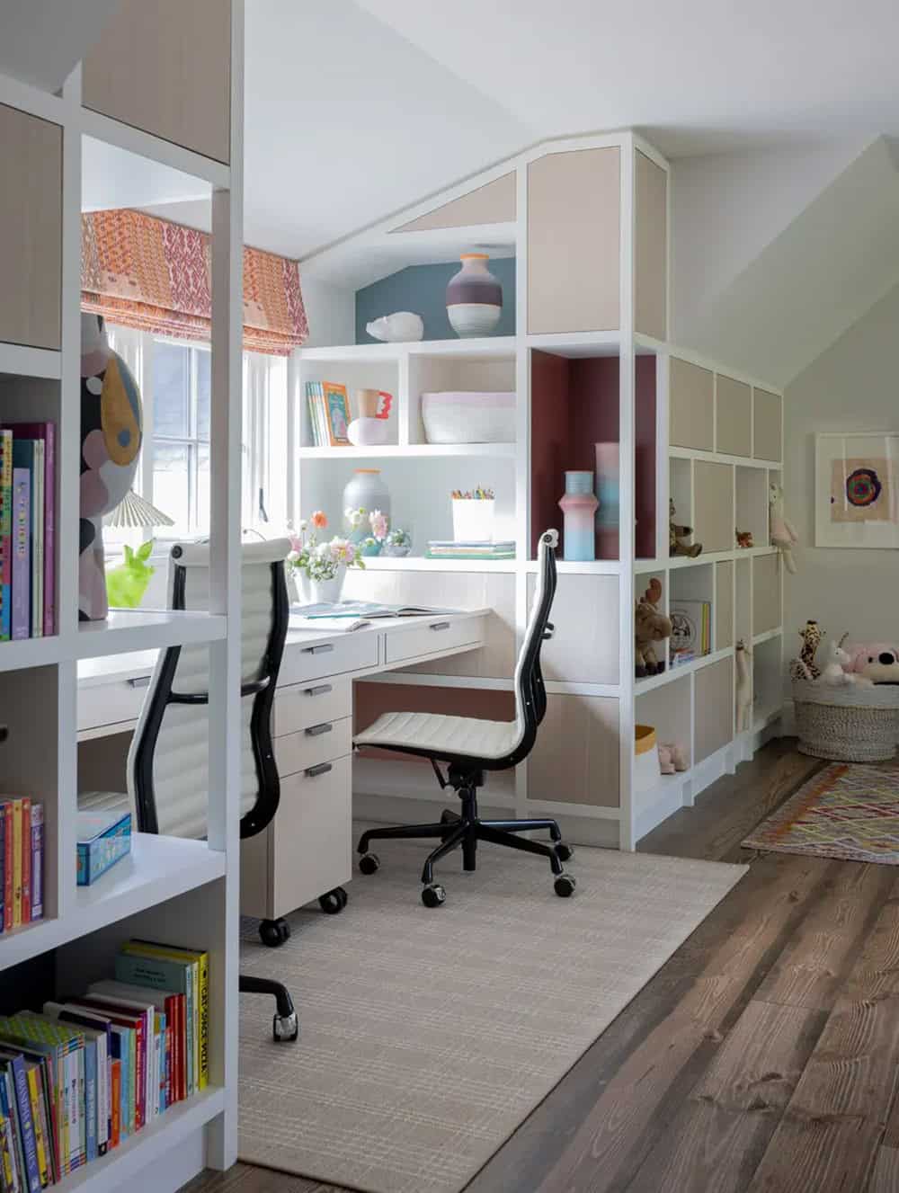 Kids' study nook with white built-ins and colorful accent shelving