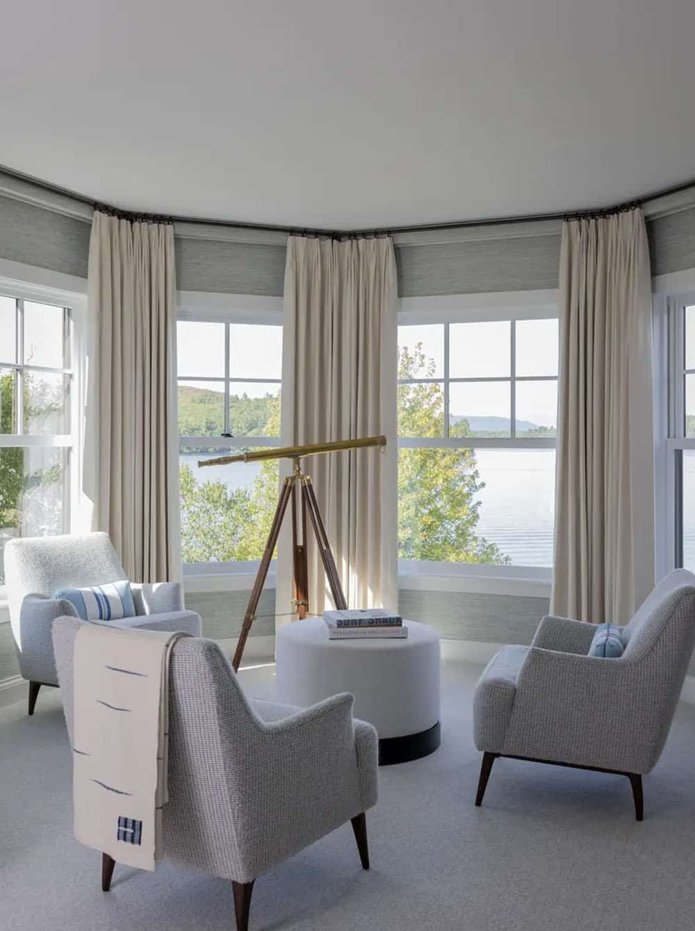 Turret sitting room with brass telescope and lake-facing armchairs