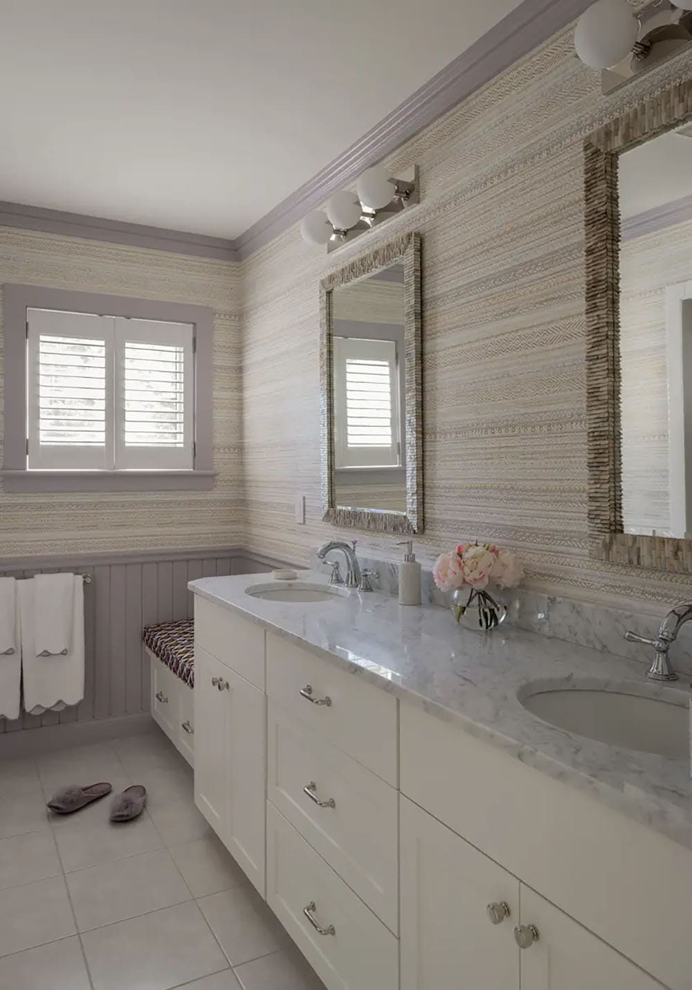 Purple-trimmed bathroom with double vanity and textured wallpaper