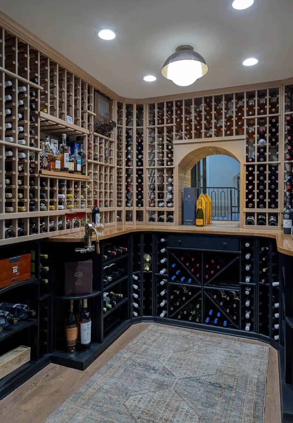 Wine cellar with wood racks, arched doorway, and patterned rug