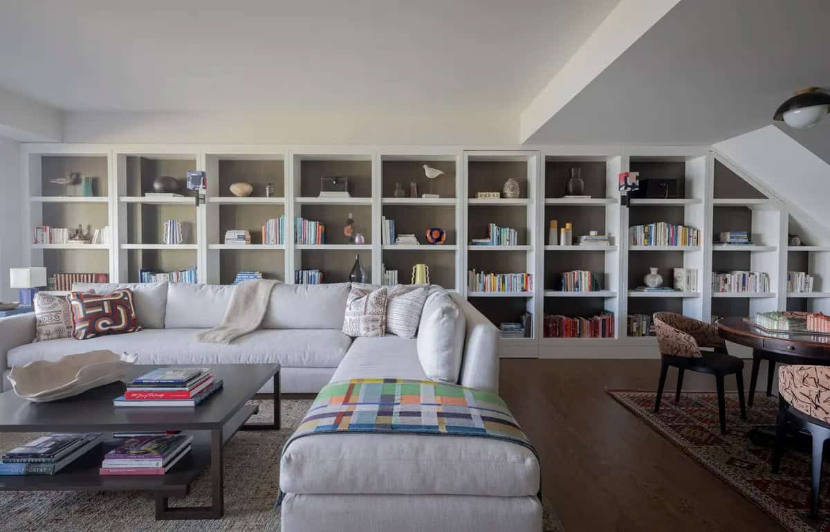 Family room with white built-in bookshelves and sectional sofa