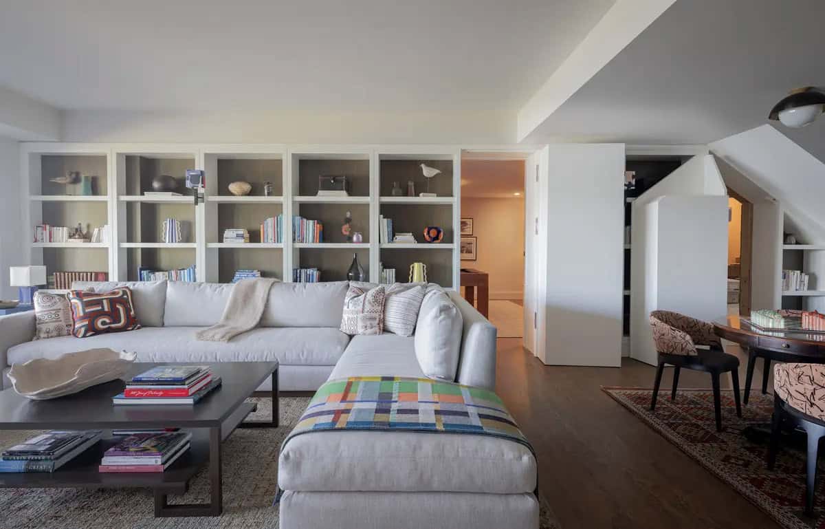 Family room with bookshelves, sectional sofa, and game table nook
