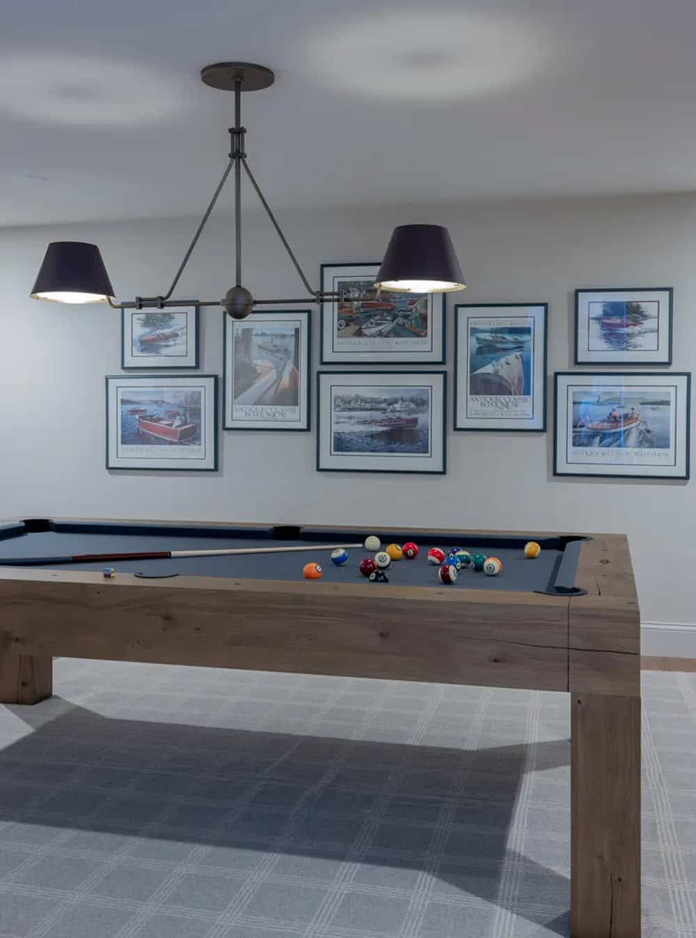Game room with billiards table and framed antique boat show posters