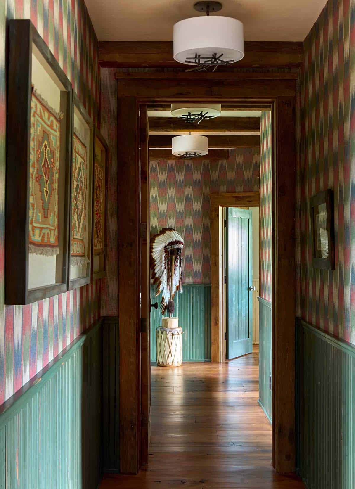 Hallway with kilim art and Native American headdress on display
