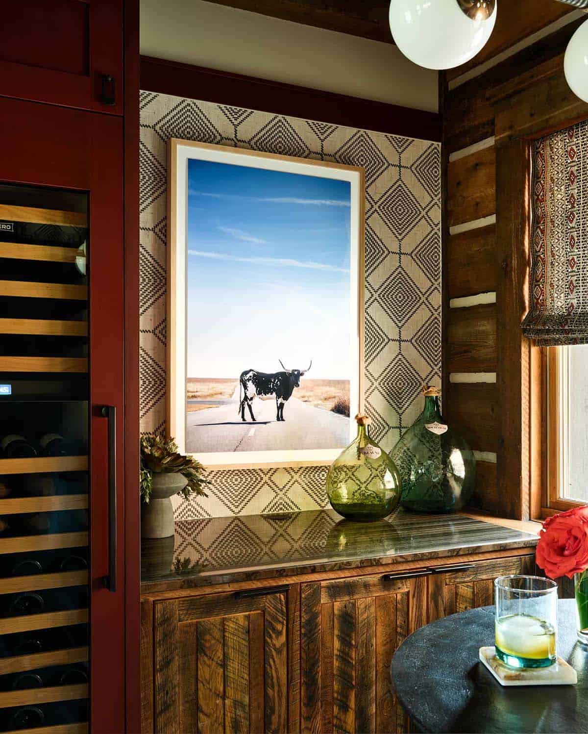 Bar nook with a framed longhorn photograph and green glass demijohns
