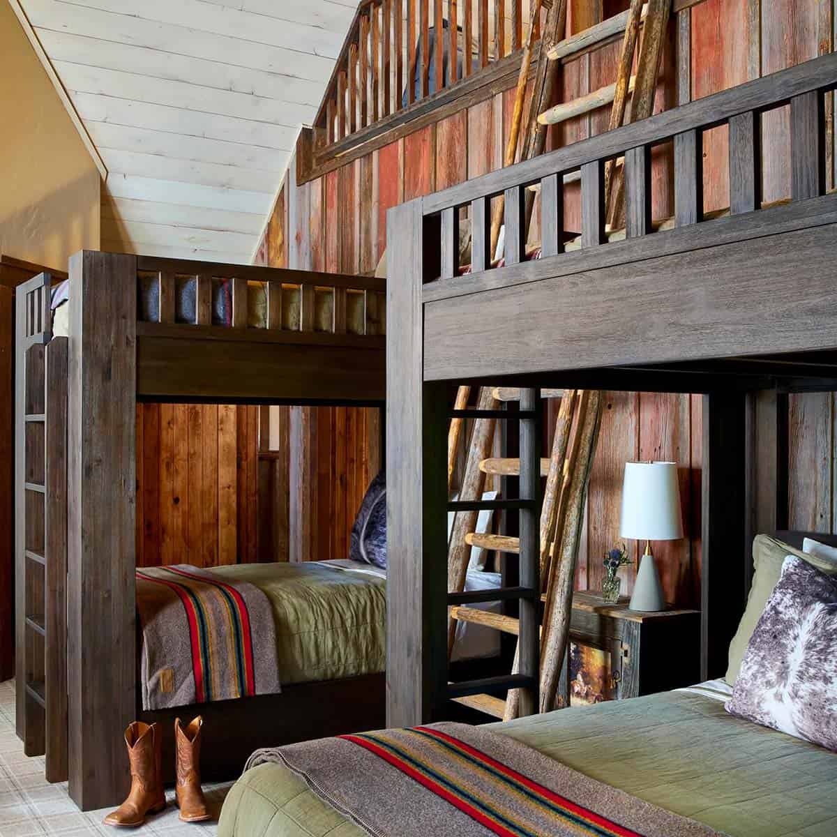 Bunk room with rustic wood beds and cowboy boots on floor
