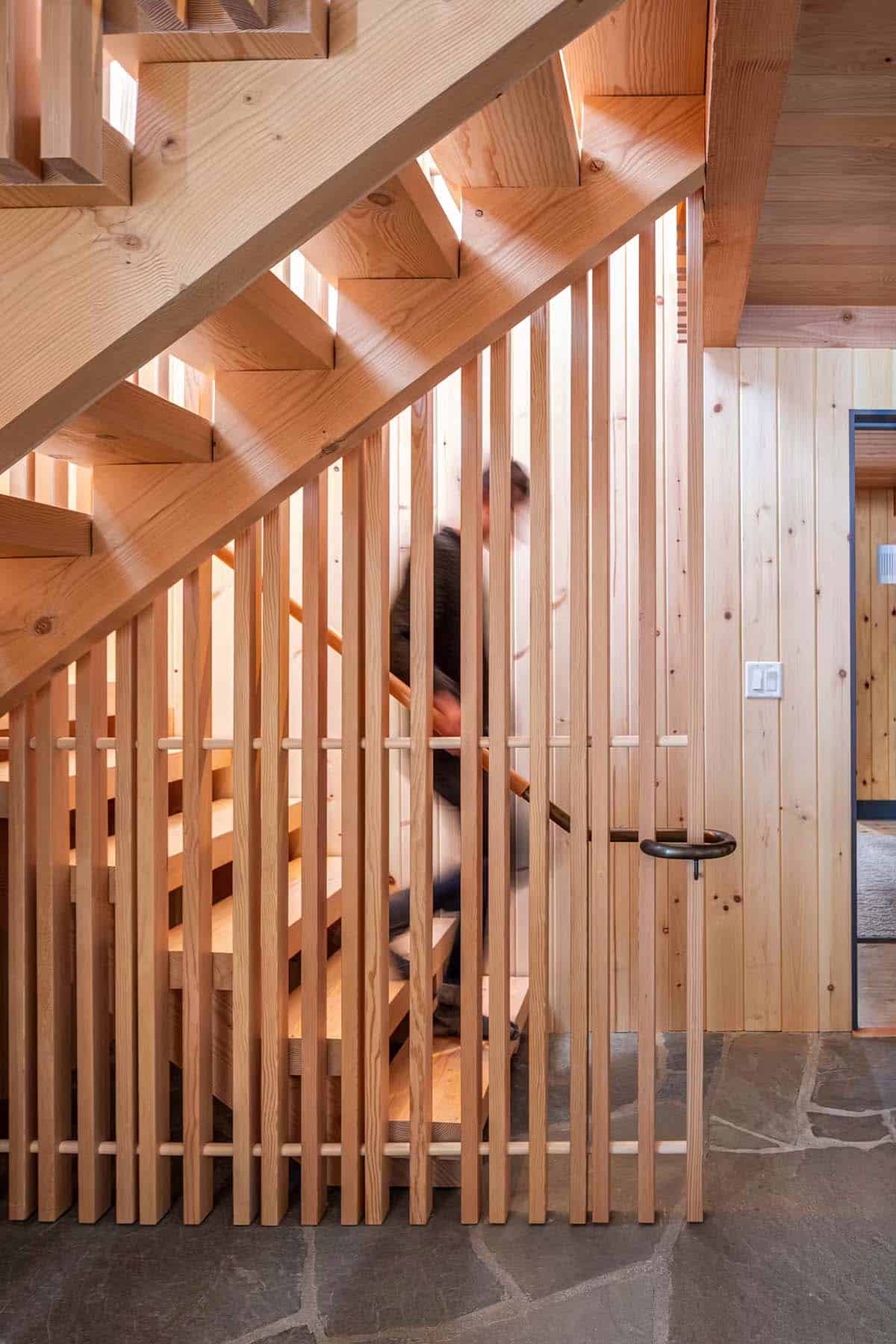 Person walking down wood slat staircase