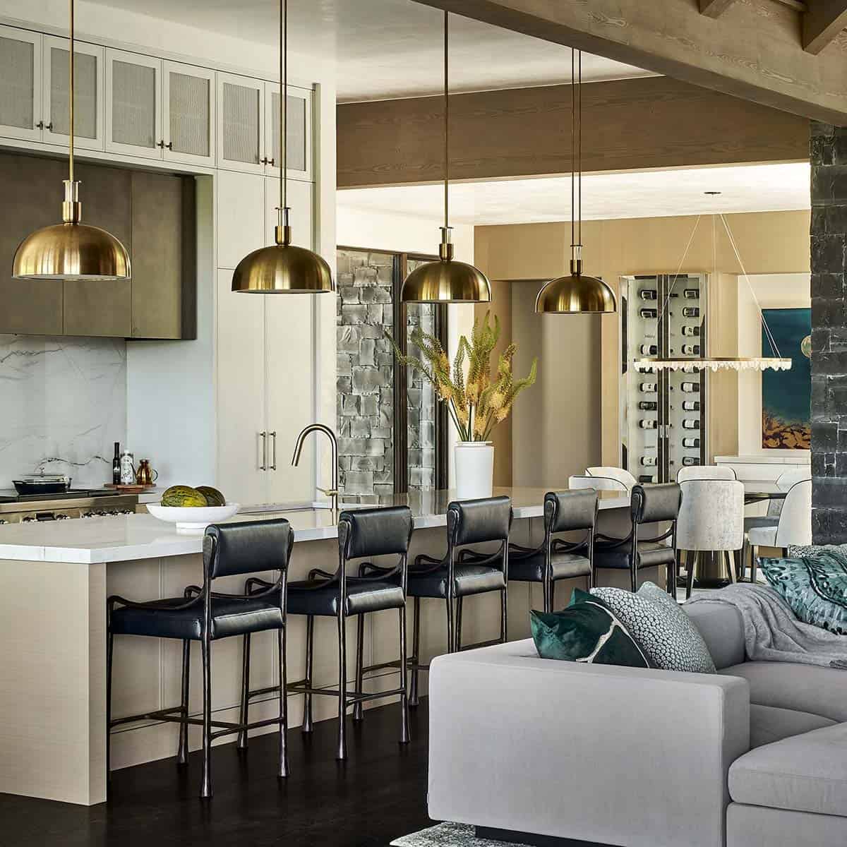 Kitchen with brass dome lighting overlooking gray sectional and dining nook