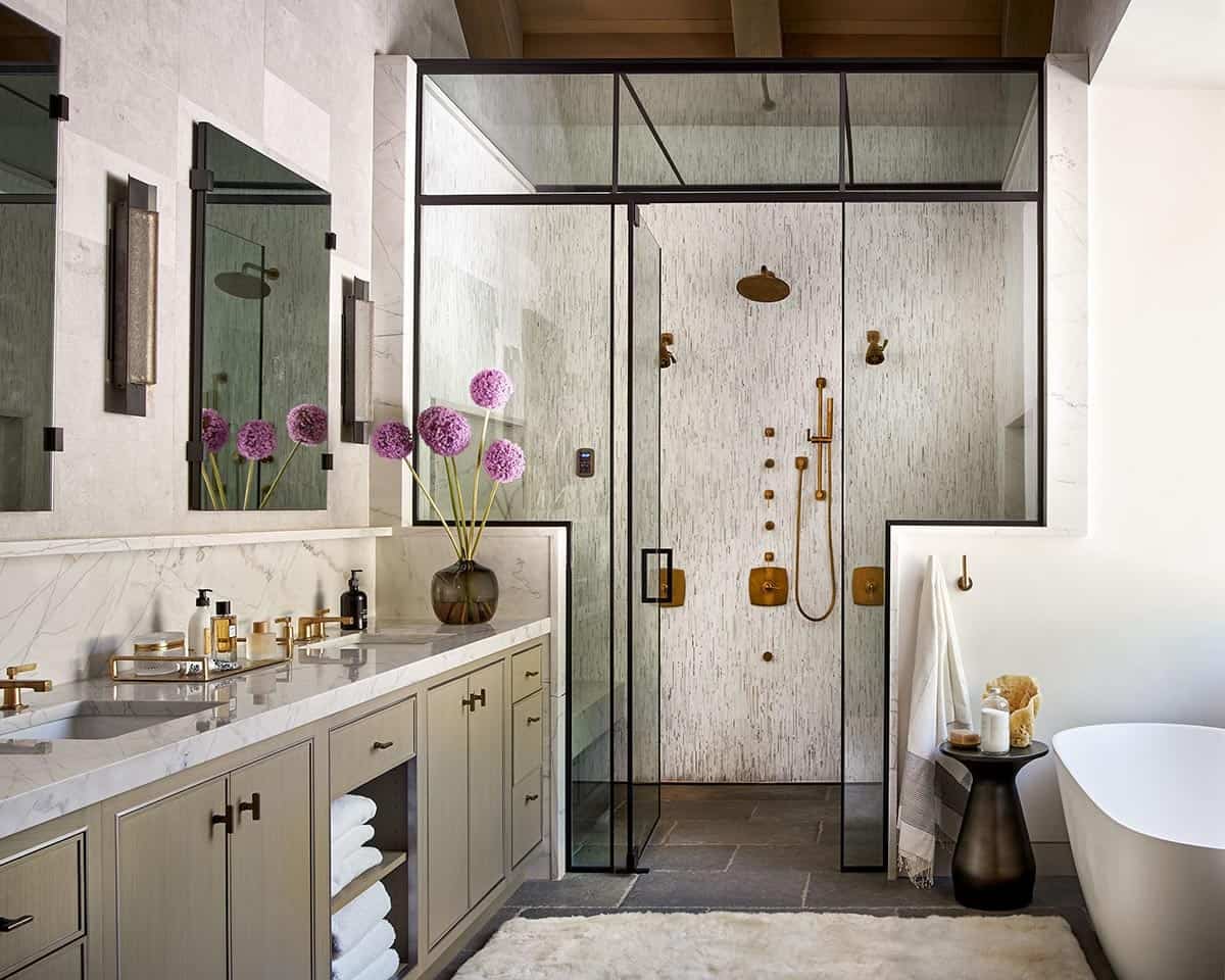 Spa-style bathroom with glass shower, freestanding tub, and marble double vanity