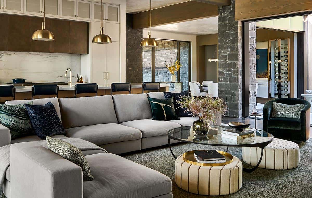 Open living area with gray sectional, kitchen, and dining room beyond