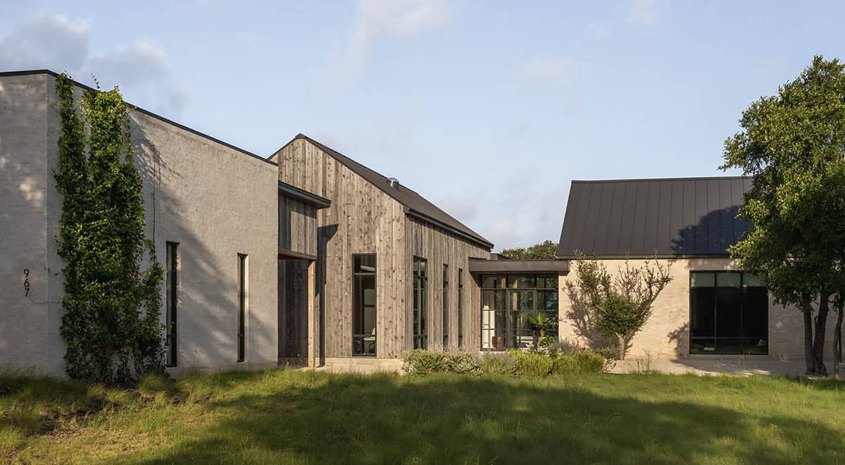 Wood and stone facade connects to the home's main gabled wing