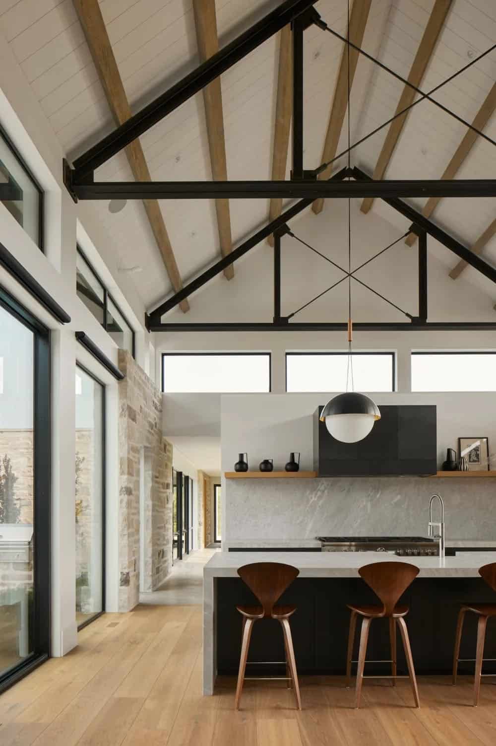 Vaulted kitchen interior with exposed wood beams and steel trusses