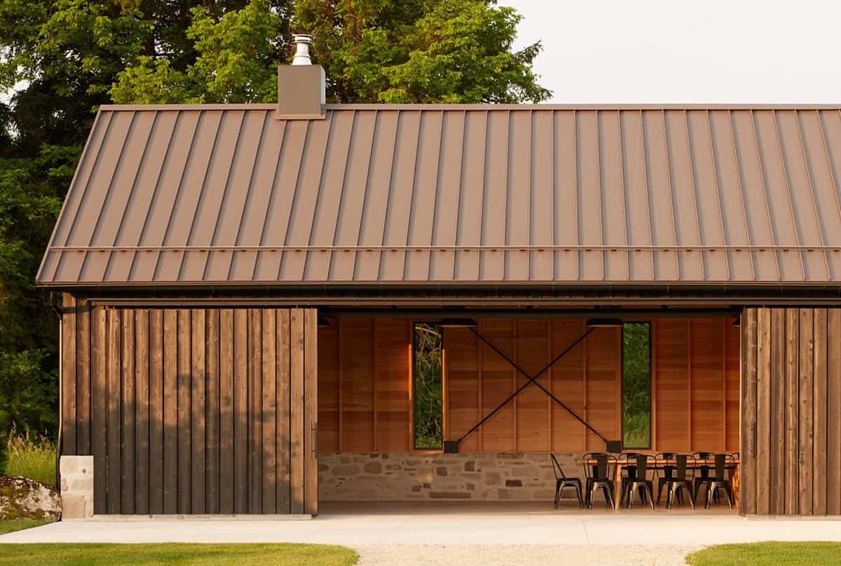 Close-up of gathering pavilion with sliding wood doors open to dining area