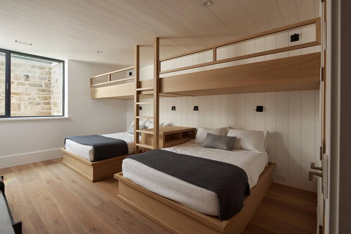 Built-in bunk beds with wood frames in a shared bedroom