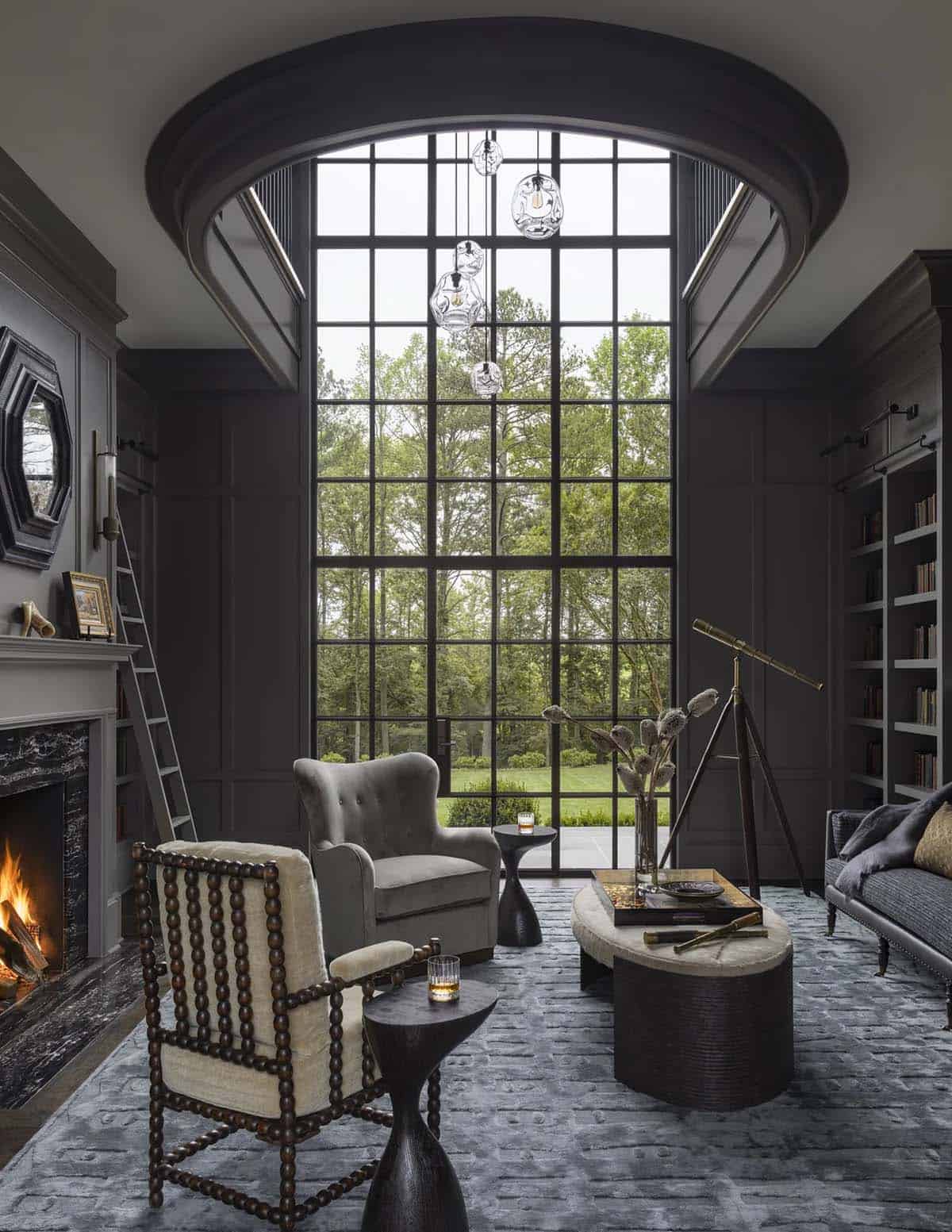 Dark moody library nook with arched window, telescope, and velvet armchairs