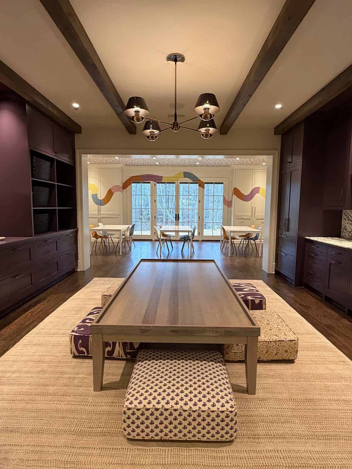 Billiard room with plum built-ins, cushioned floor seating, and a view into the art/craft room