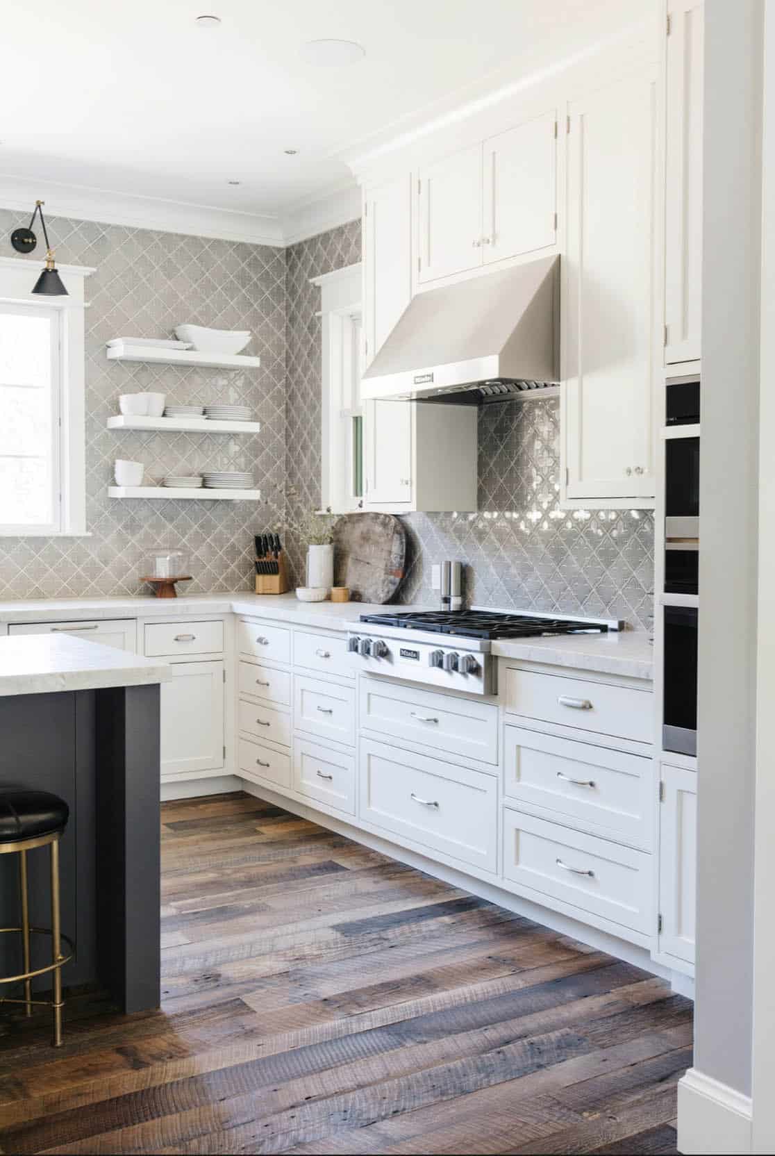 Kitchen range and hood with gray arabesque tile backsplash and open shelving