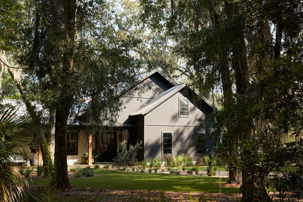 Gable end exterior in charcoal siding beneath spanish moss