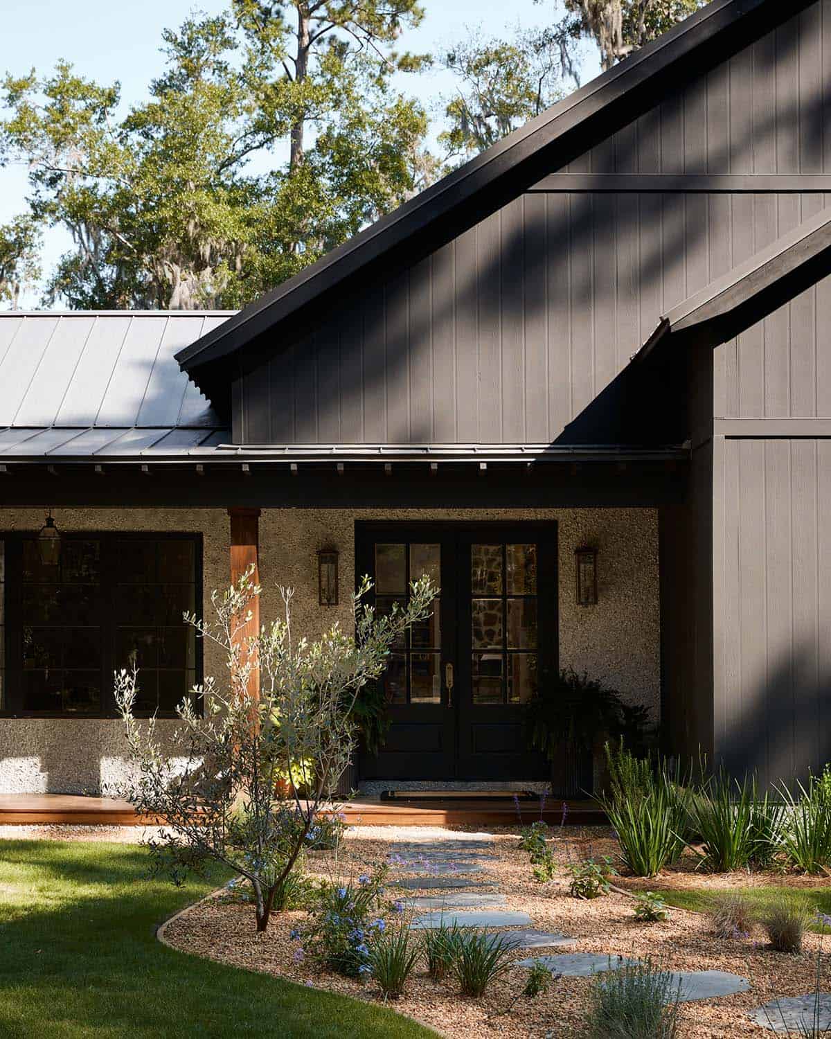 Front entry with black double doors and gravel walkway