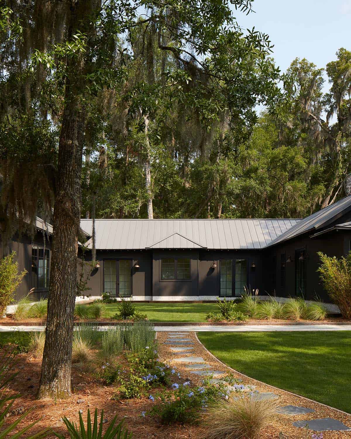 Rear exterior with standing seam roof and native plant beds