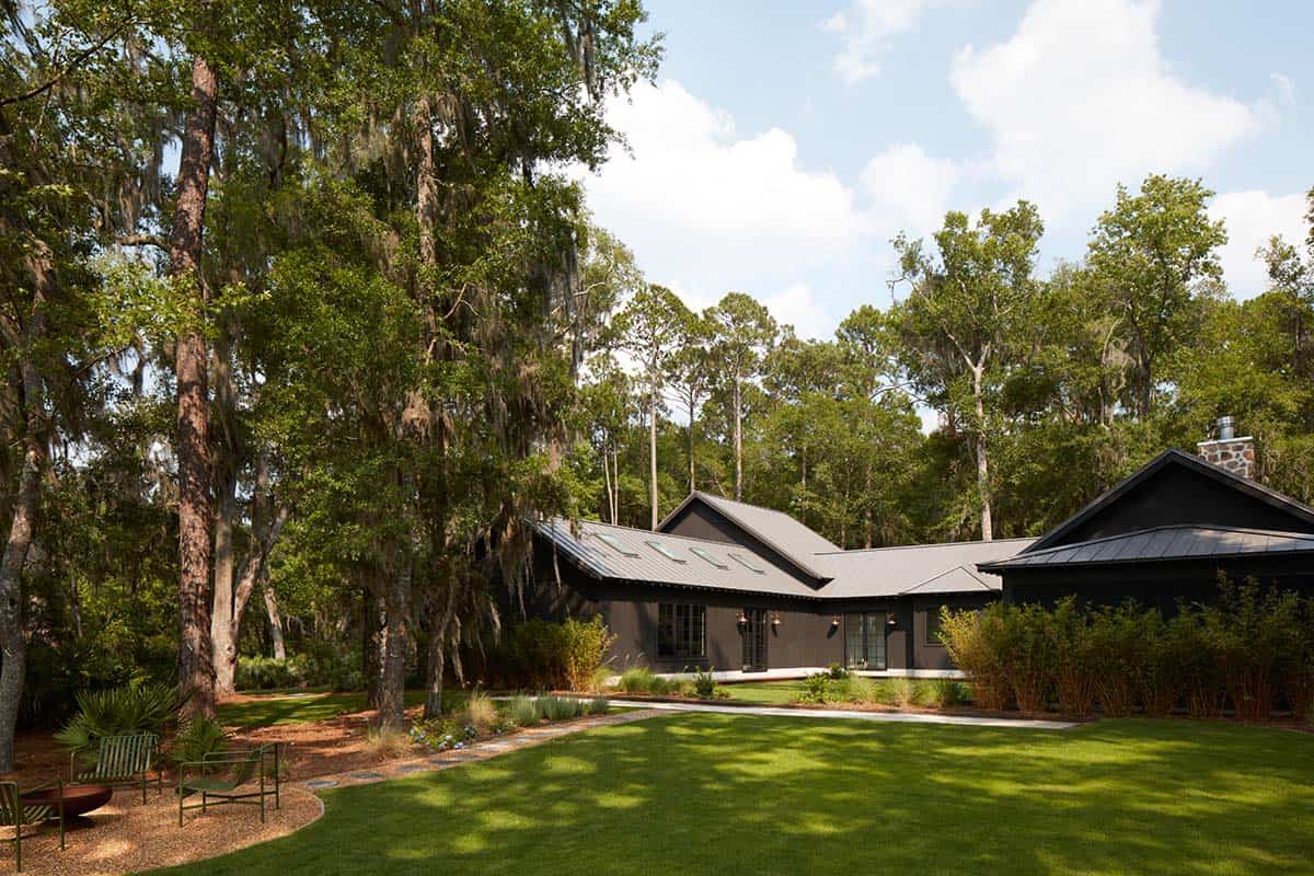 Backyard lawn with fire pit chairs beneath spanish moss oaks