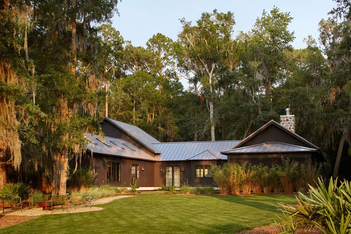 Standing seam roofline glowing at sunset behind palmetto plantings