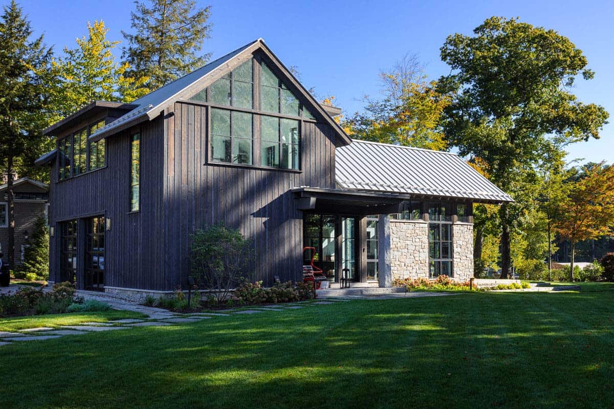 Barn exterior with dark wood siding and glass gable end