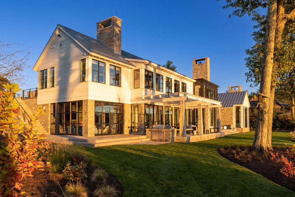 Lake house exterior with pergola and stone chimney